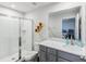 Modern bathroom with a walk-in shower and gray vanity at 2920 Oak Park Way # Apt A, Orlando, FL 32822