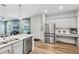 Modern kitchen with stainless steel appliances and an island at 2920 Oak Park Way # Apt A, Orlando, FL 32822