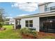 Screened porch with AC unit and lush landscaping at 2920 Oak Park Way # Apt A, Orlando, FL 32822