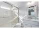 Modern bathroom with a walk-in shower and white vanity at 128 Chelsea Place Ave, Ormond Beach, FL 32174