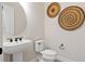Small powder room with pedestal sink and unique wall decor at 1623 Green Orchard St, St Cloud, FL 34771