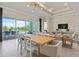 Dining area with a large table and chairs, adjacent to living room and pool at 1623 Green Orchard St, St Cloud, FL 34771