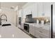Modern kitchen features white cabinets, quartz countertops, and a sleek backsplash at 1623 Green Orchard St, St Cloud, FL 34771