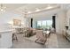 Open living space with modern furniture, large windows, and view of backyard at 1623 Green Orchard St, St Cloud, FL 34771