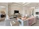 Living room with comfortable seating, a large TV, and brick accent wall at 1623 Green Orchard St, St Cloud, FL 34771