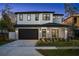 Two-story home with gray brick exterior, black garage door, and a landscaped front yard at 1627 Illinois St, Orlando, FL 32803