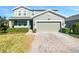 Two-story house with gray siding, a two-car garage, and a landscaped front yard at 1949 Mountain Pine St, Ocoee, FL 34761