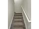 Carpeted stairs with a white handrail at 1949 Mountain Pine St, Ocoee, FL 34761