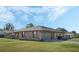 Another side view of the brick ranch home, highlighting the garage and yard at 2133 E Parkton Dr, Deltona, FL 32725