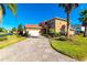 Two-story house with paver driveway and palm trees at 284 Vista Dr, Davenport, FL 33897