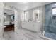 Bathroom with double vanity, walk-in shower, and access to bedroom at 2912 Sunset Lakes Blvd, Kissimmee, FL 34747