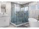 Bright bathroom with a walk-in shower, soaking tub, and marble tile at 2912 Sunset Lakes Blvd, Kissimmee, FL 34747