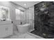 Luxurious bathroom featuring a freestanding tub and a large shower at 2912 Sunset Lakes Blvd, Kissimmee, FL 34747