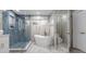 Spacious bathroom with freestanding tub, walk-in shower, and marble floors at 2912 Sunset Lakes Blvd, Kissimmee, FL 34747