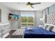 Comfortable main bedroom with a king-size bed and access to a balcony at 2912 Sunset Lakes Blvd, Kissimmee, FL 34747