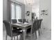Formal dining room with large table and gray chairs at 2912 Sunset Lakes Blvd, Kissimmee, FL 34747
