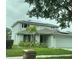Two-story house with solar panels and landscaped lawn at 2912 Sunset Lakes Blvd, Kissimmee, FL 34747