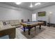 Spacious game room with a pool table and comfortable seating at 2912 Sunset Lakes Blvd, Kissimmee, FL 34747
