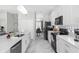 Modern kitchen with white cabinetry, stainless steel appliances and marble flooring at 2912 Sunset Lakes Blvd, Kissimmee, FL 34747