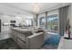 Open concept living room and kitchen with large sectional sofa at 2912 Sunset Lakes Blvd, Kissimmee, FL 34747