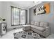 Comfortable living room with sectional sofa and Mickey Mouse art at 2912 Sunset Lakes Blvd, Kissimmee, FL 34747