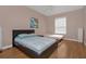 Bright bedroom with two beds, wood floors, and a window with blinds at 3190 Dante Dr # 304, Orlando, FL 32835