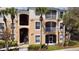 Two-story condo building with palm trees and balconies at 3190 Dante Dr # 304, Orlando, FL 32835