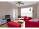 Cozy living room featuring red couches, wood floors and a large window at 3190 Dante Dr # 304, Orlando, FL 32835