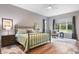 Serene bedroom with a metal framed bed and ample natural light at 3738 Chaplain Rd, Saint Cloud, FL 34772