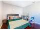 Comfortable bedroom with a queen-size bed and wood floors at 4408 Sun Village Blvd, Kissimmee, FL 34746
