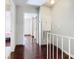 Hallway with wood floors and access to bedrooms at 4408 Sun Village Blvd, Kissimmee, FL 34746