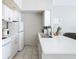 White kitchen with appliances and breakfast bar at 4408 Sun Village Blvd, Kissimmee, FL 34746