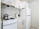 Efficient galley kitchen, features white cabinetry, and appliances at 4408 Sun Village Blvd, Kissimmee, FL 34746
