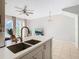 Kitchen with island, double sink, and breakfast bar at 4408 Sun Village Blvd, Kissimmee, FL 34746