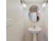 Clean and modern powder room with pedestal sink and oval mirror at 5159 Sabal Branch Cv, Oviedo, FL 32765