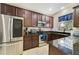 Modern kitchen with stainless steel appliances and dark wood cabinets at 5159 Sabal Branch Cv, Oviedo, FL 32765