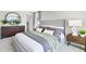 Main bedroom with wood dresser and gray bedding at 545 Zinfandel Dr, Holly Hill, FL 32117