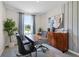 Home office with wood desk, two chairs, and natural light at 545 Zinfandel Dr, Holly Hill, FL 32117