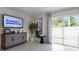 Living room with a large TV and access to the backyard at 545 Zinfandel Dr, Holly Hill, FL 32117
