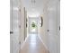 Clean and modern hallway with neutral-colored walls and tile flooring, showcasing access to rooms at 547 Zinfandel Dr, Holly Hill, FL 32117