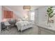 Pastel bedroom with a metal bed frame, rainbow bedding, and a desk at 6018 Forest Perch Dr, St Cloud, FL 34771