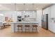 Modern kitchen with white cabinets, large island, and stainless steel appliances at 6018 Forest Perch Dr, St Cloud, FL 34771