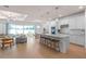 Open concept kitchen with island, white cabinets, and wood floors at 6018 Forest Perch Dr, St Cloud, FL 34771
