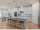 Modern kitchen with white cabinets, large island, and stainless steel appliances at 6018 Forest Perch Dr, St Cloud, FL 34771