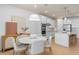 Modern kitchen with white cabinets, island, and a round dining table at 6018 Forest Perch Dr, St Cloud, FL 34771