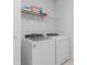 Laundry room with washer and dryer, and a shelf for storage at 6018 Forest Perch Dr, St Cloud, FL 34771