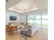 Living room with light gray sofa, wood floors, and access to the backyard at 6018 Forest Perch Dr, St Cloud, FL 34771