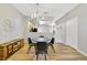 Dining area with a round table, chandelier, and wood floors at 6810 Hochad Dr, Orlando, FL 32819