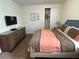 King-size bed, dresser, and closet in bedroom at 7609 Brookhurst Ln, Kissimmee, FL 34747