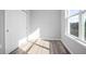Bright bedroom with gray walls, wood-look floors, and double door closet at 765 6Th Ave, Osteen, FL 32764